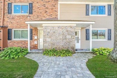 Entrance to property featuring brick siding