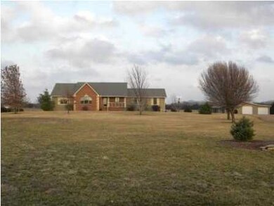 Front with view of detached garage/storage/shop 3/
