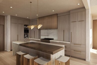 Kitchen featuring modern cabinets, wood counters, a breakfast bar, a kitchen island with sink, and recessed lighting