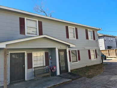The property has a wrought iron gate enclosing the