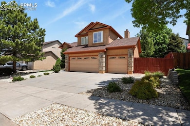 View of front of house with concrete driveway, stucco siding, a chimney, a shingled roof, and a garage
