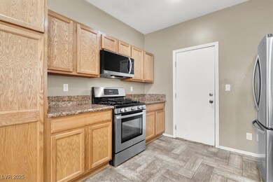 Kitchen with stainless steel appliances, light bro
