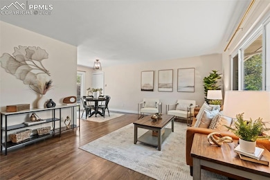 Living area with wood finished floors and baseboards
