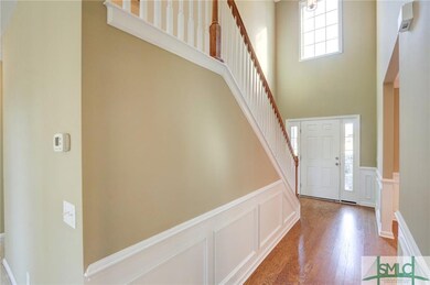 Grand 2 story foyer entry with wainscoting and har