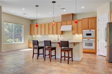 Kitchen with freestanding refrigerator, range hood