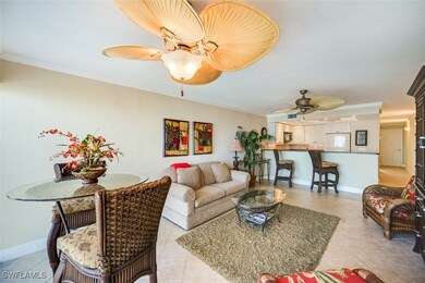 Tiled living room featuring ceiling fan and orname