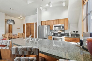 Kitchen featuring stainless steel appliances, a si