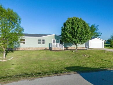 View of front of house with a front lawn and a garage