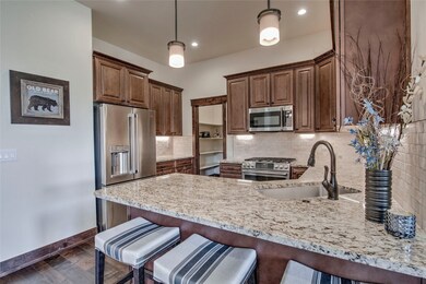 Kitchen features bar seating and walk in pantry.