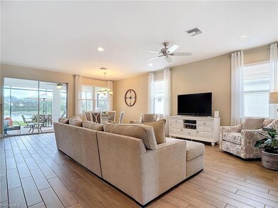 Living room with ceiling fan with notable chandeli
