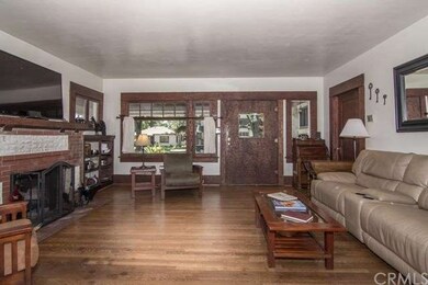 Original brick fireplace warms the living room wit