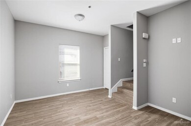 Spare room featuring wood finished floors and stairway