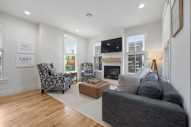 Living room with a fireplace, light wood finished 