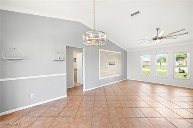 Unfurnished room with a chandelier, vaulted ceilin