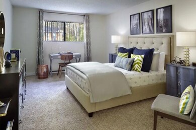 Bedroom with light carpet and a textured ceiling