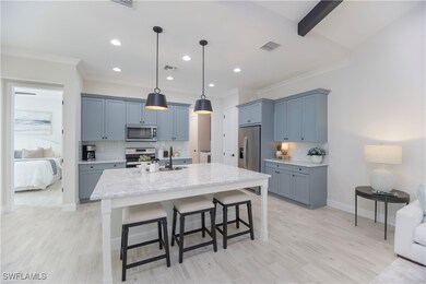 Kitchen with a breakfast bar area, hanging light f