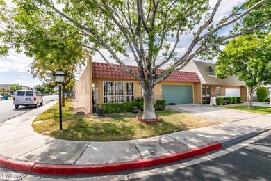 View of front of home with a tiled roof, driveway,