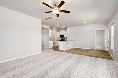 The spacious open-concept living area is filled with natural light and cozy vibes—your go-to spot for relaxing or gathering with loved ones.