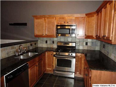Kitchen has solid surface counters, beautiful cabi