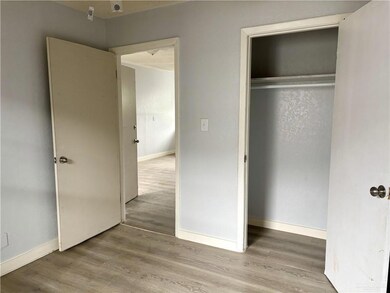 Unfurnished bedroom with wood finished floors and a closet