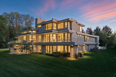 Acreage woodland setting in harmony with a wealth of windows combine to lovely effects both inside & out! The brilliance of great design by Architect Charles Stinson is apparent in every sight line & illuminations by night or by day. Splendid indeed!