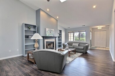 Spacious Living room with front facing triple window with mullion also has foyer with ceramic tile, Double width coat closet and teal painted front door!