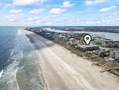 Aerial view featuring a water view and a view of the beach