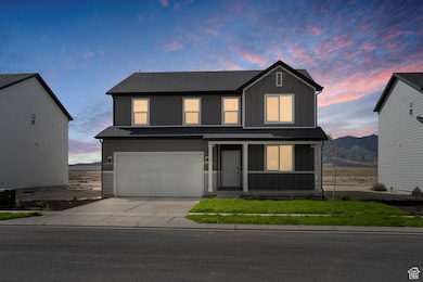 **DISCLAIMER - some exterior and interior options may vary**Traditional-style house with board and batten siding, a porch, concrete driveway, and a garage