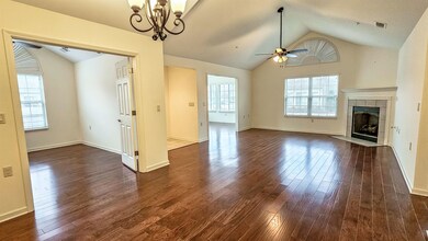 Large den with hardwood flooring and gas fireplace
