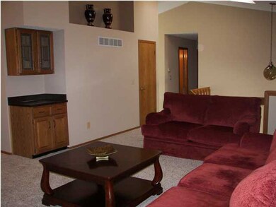 Large living room with new carpet.
