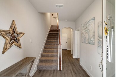 Entry stairs with light wood-type flooring and a m