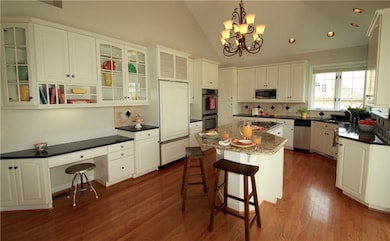 Timeless white kitchen with granite counters, larg