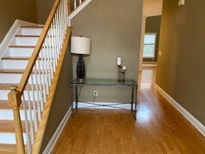 Staircase featuring baseboards and wood finished f