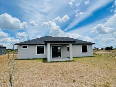 Rear view of property featuring a shingled roof, a