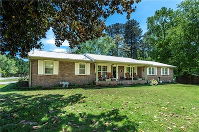 Single story home with a porch, brick siding, a fr
