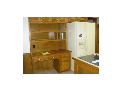 Kitchen desk area, refrigerator and stovetop