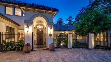 A tile roof and wrought iron gate compliment the stucco exterior