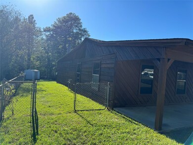 View of property exterior with a lawn and a patio