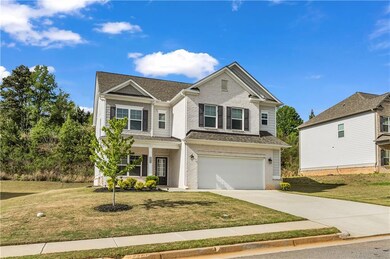 Traditional home with roof with shingles, driveway