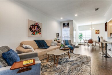 Living area featuring crown molding, wood-type flooring, a chandelier, and recessed lighting