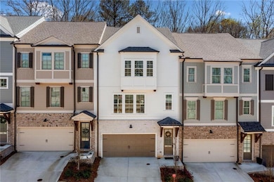 Multi unit property featuring driveway, an attached garage, a shingled roof, and brick siding