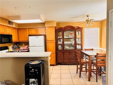 Kitchen featuring black microwave, freestanding re