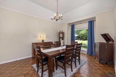 Dining area featuring crown molding, a chandelier,