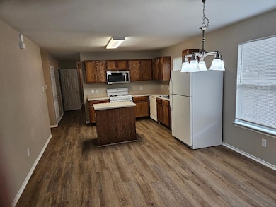 Kitchen with white appliances, dark wood finished