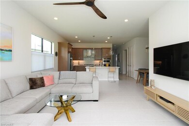 Tiled living room featuring ceiling fan