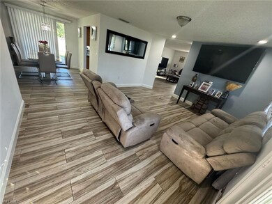 Living room featuring wood tiled floor, a notable 
