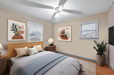 Bedroom with multiple windows and ceiling fan