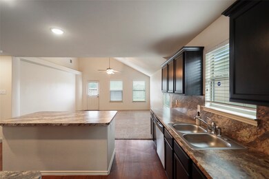 Kitchen boasts an island and stainless steel appli