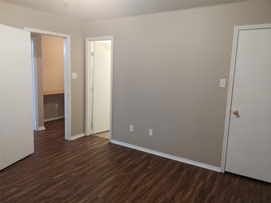 Spare room with dark wood-type flooring