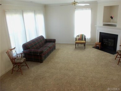 The living room features a corner fireplace, tripl